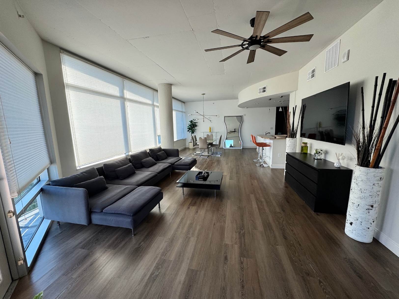 A living room with a large television

Description automatically generated