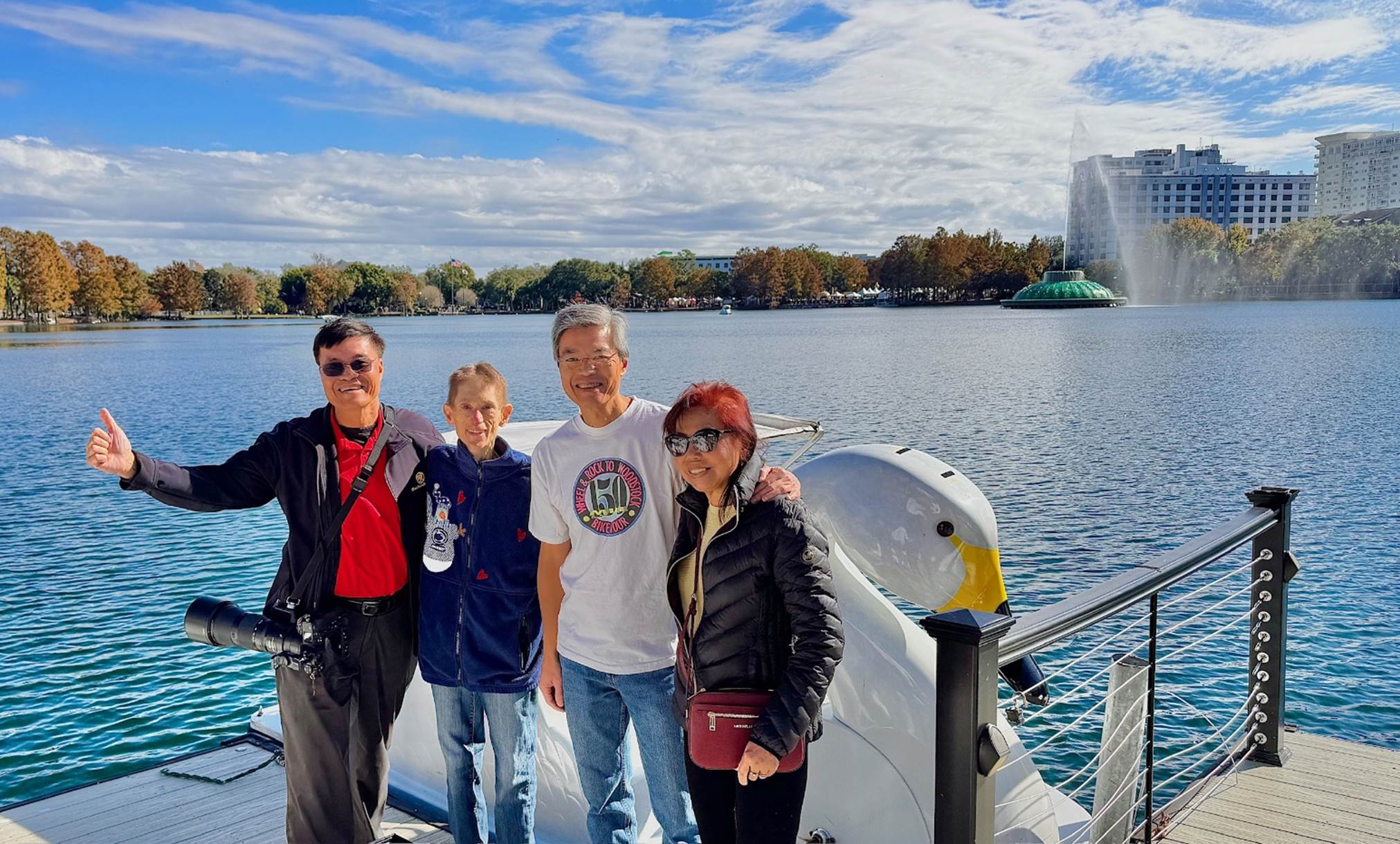 A group of people standing on a boat

Description automatically generated