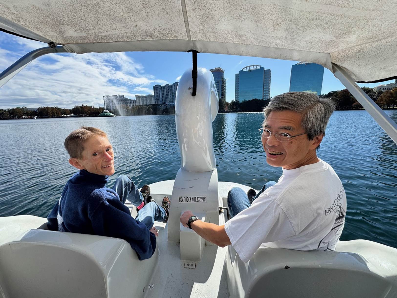 A person and child on a boat

Description automatically generated