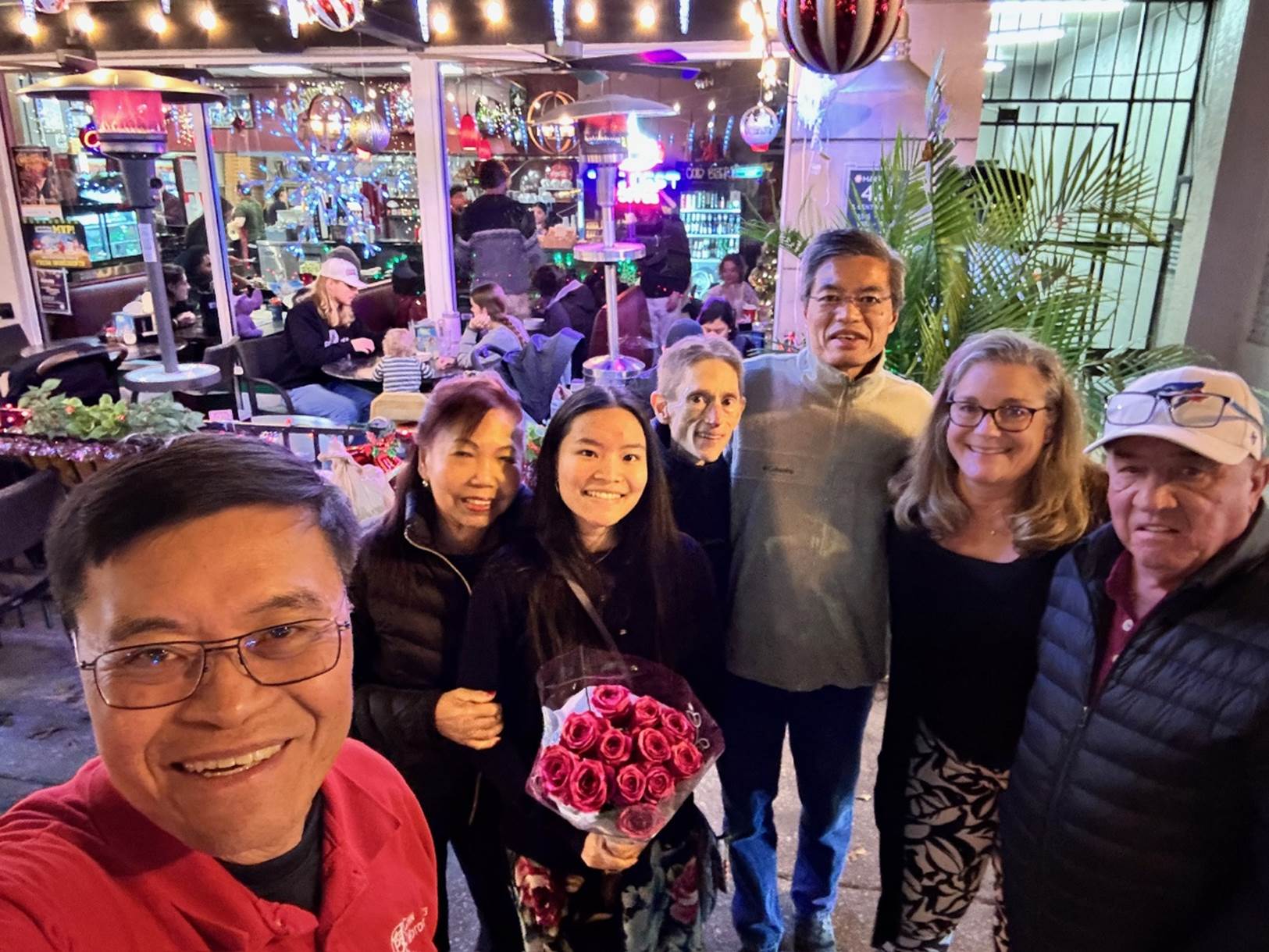 A group of people posing for a photo

Description automatically generated