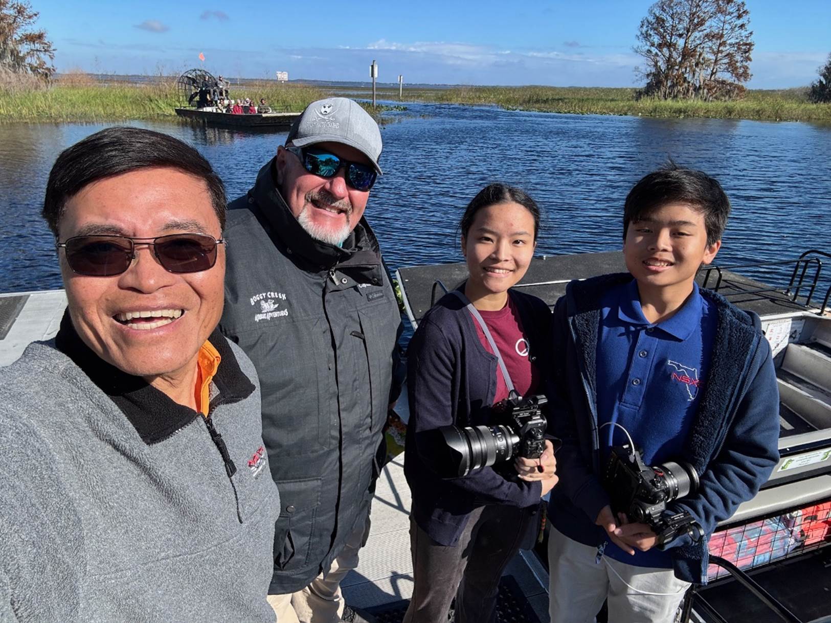 A group of people posing for a photo

Description automatically generated