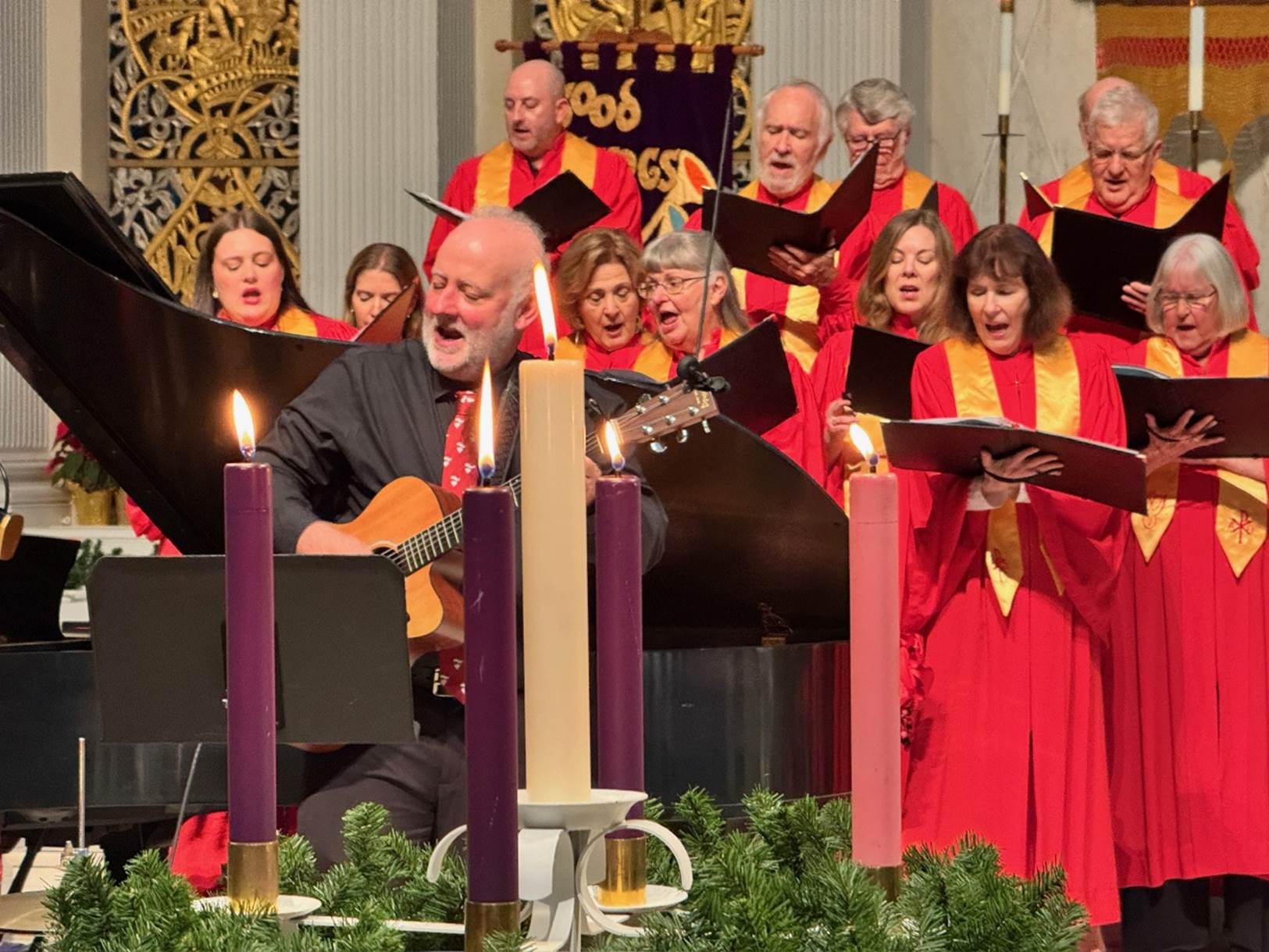 A group of people singing in a church

Description automatically generated