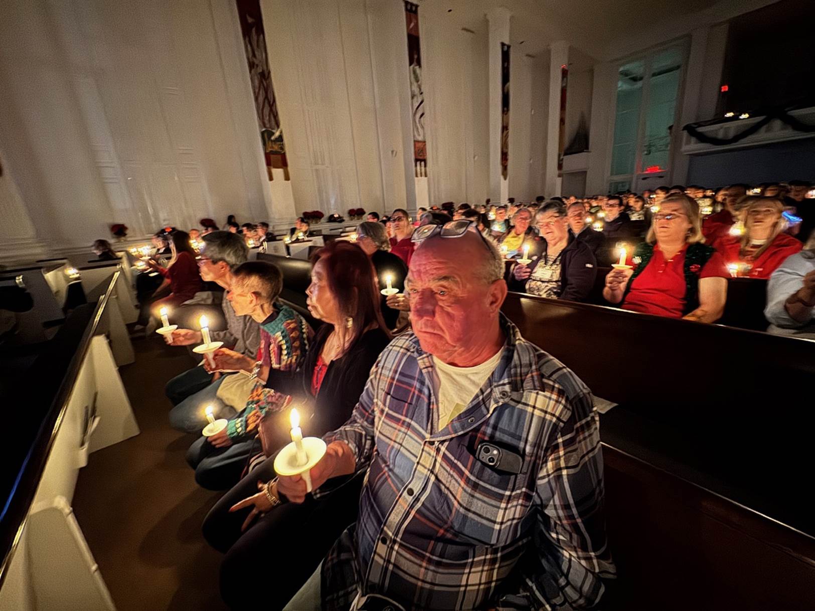 A group of people holding candles

Description automatically generated