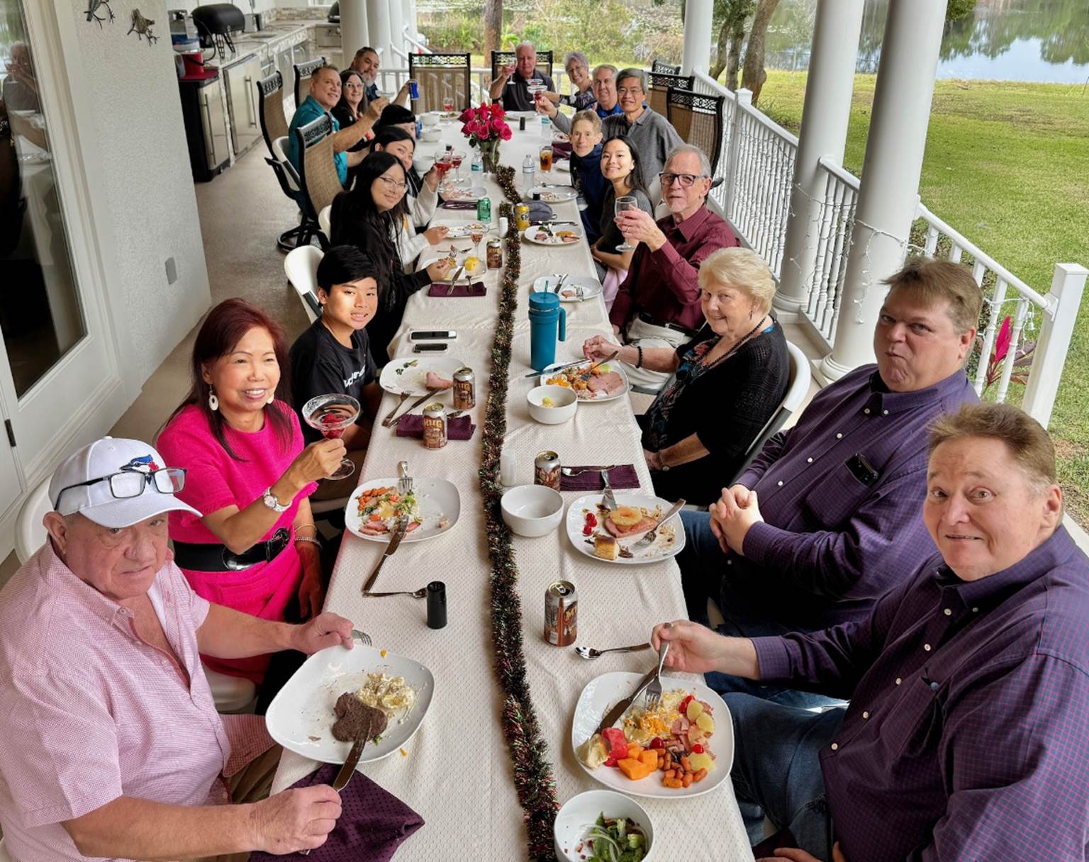 A group of people eating at a long table

Description automatically generated