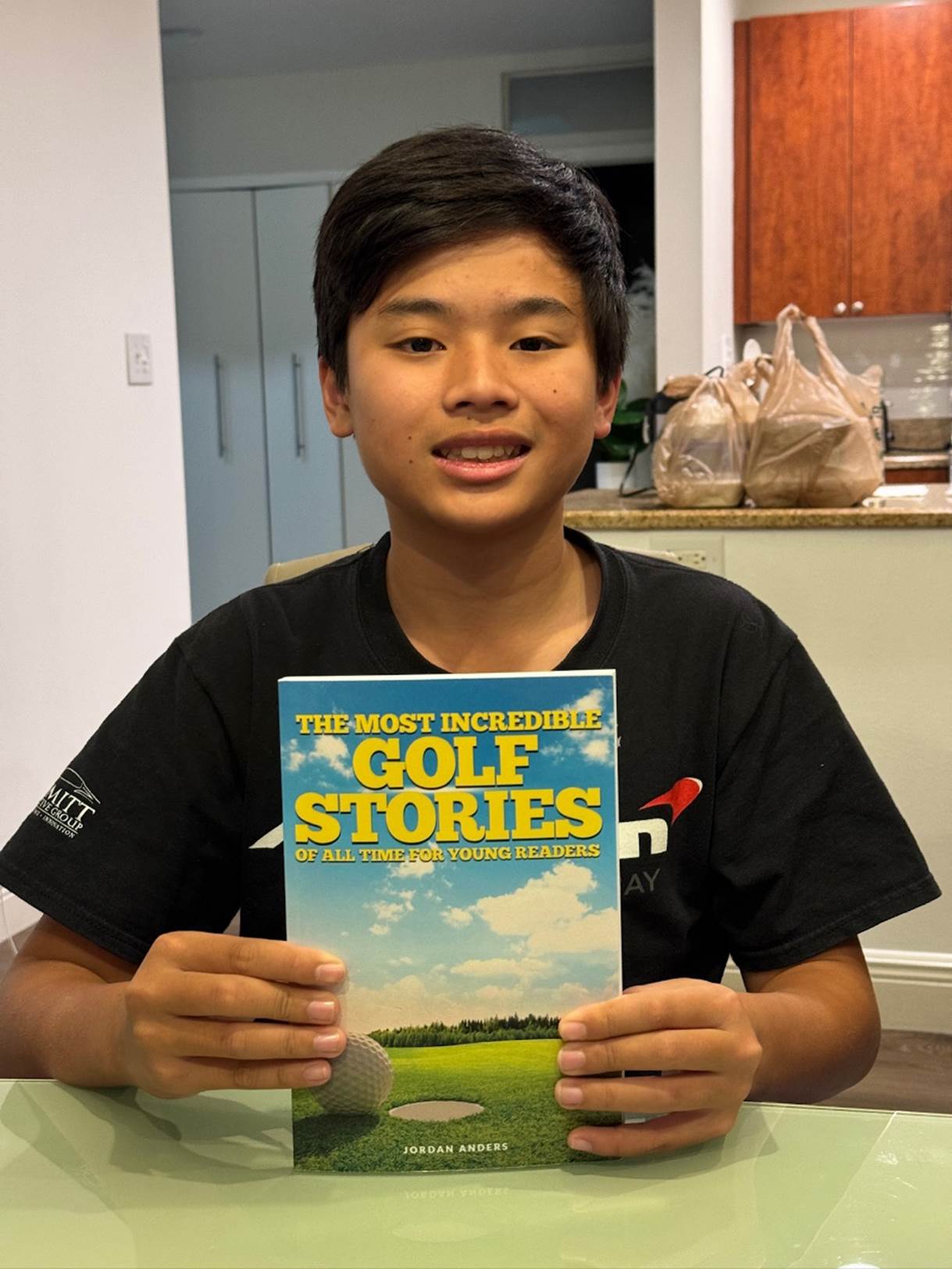 A child holding a book

Description automatically generated