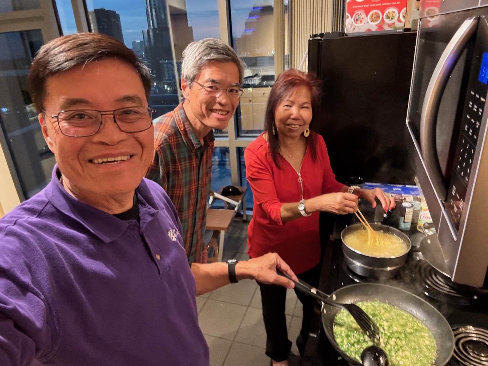 A group of people cooking in a kitchen

Description automatically generated