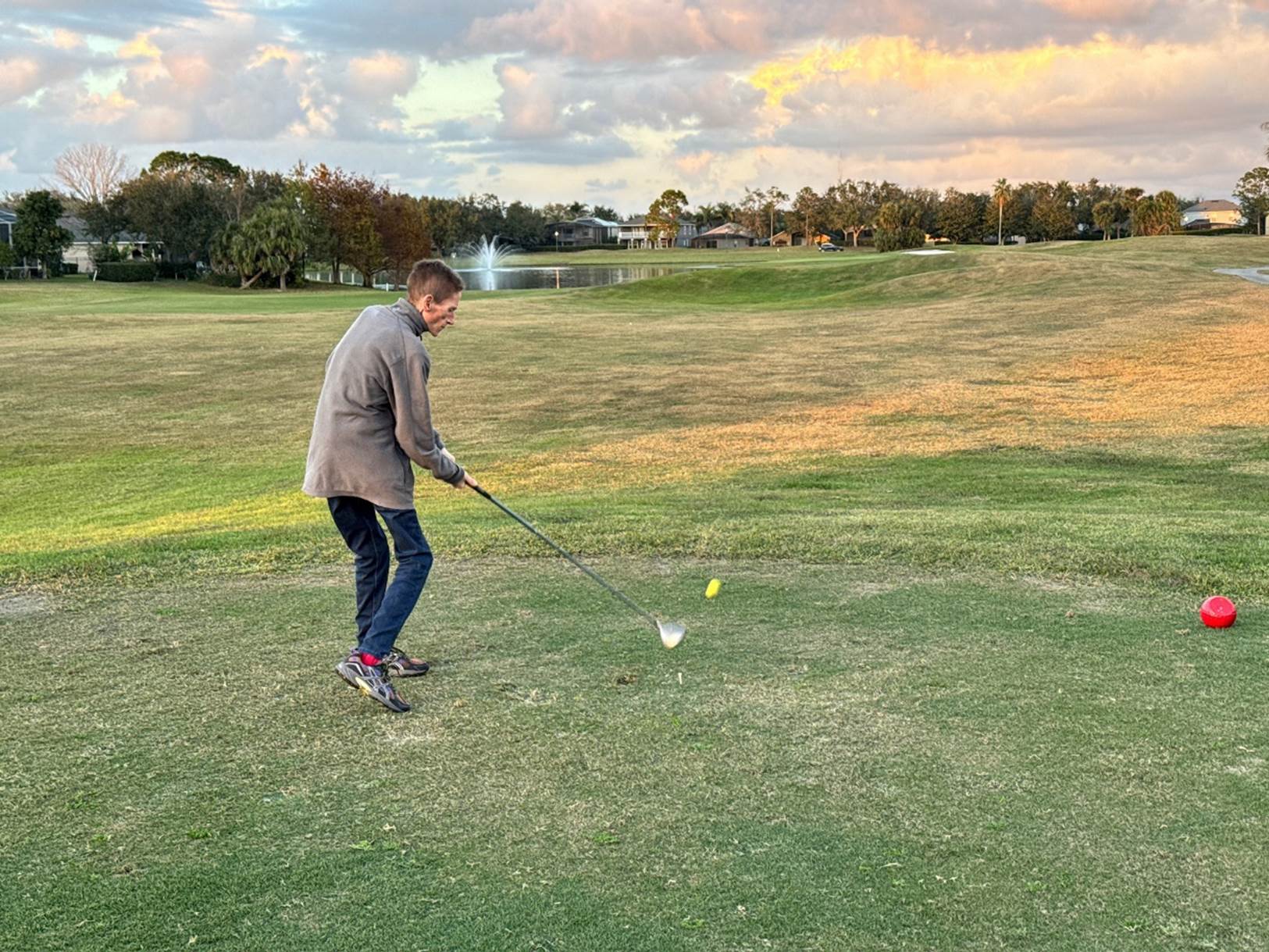 A person playing golf on a golf course

Description automatically generated