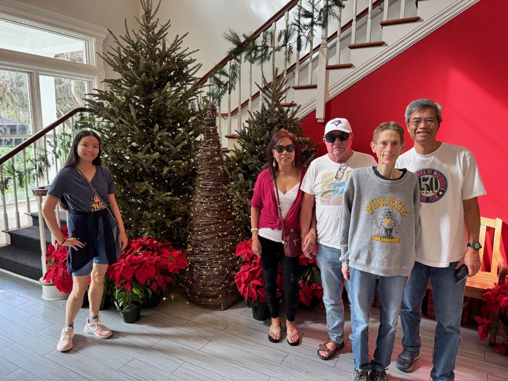 A group of people standing in front of a staircase

Description automatically generated
