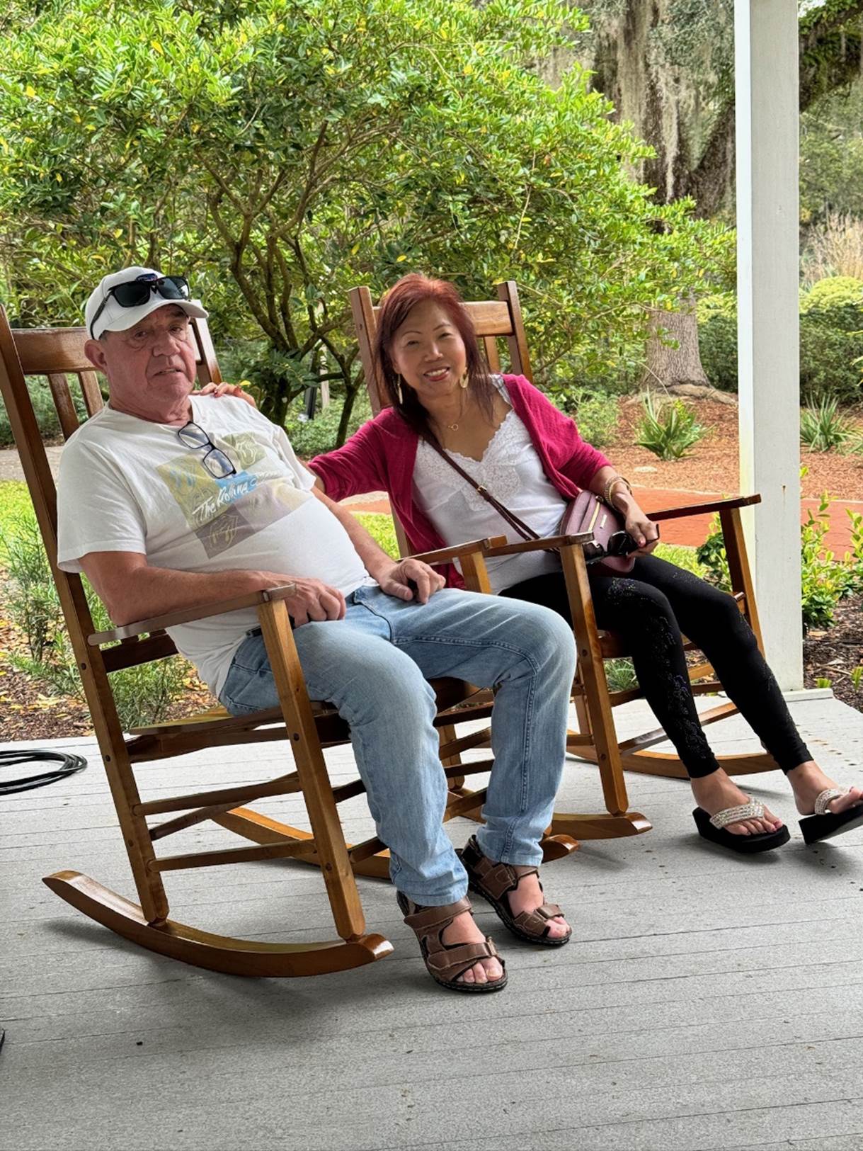 A person and person sitting in rocking chairs

Description automatically generated