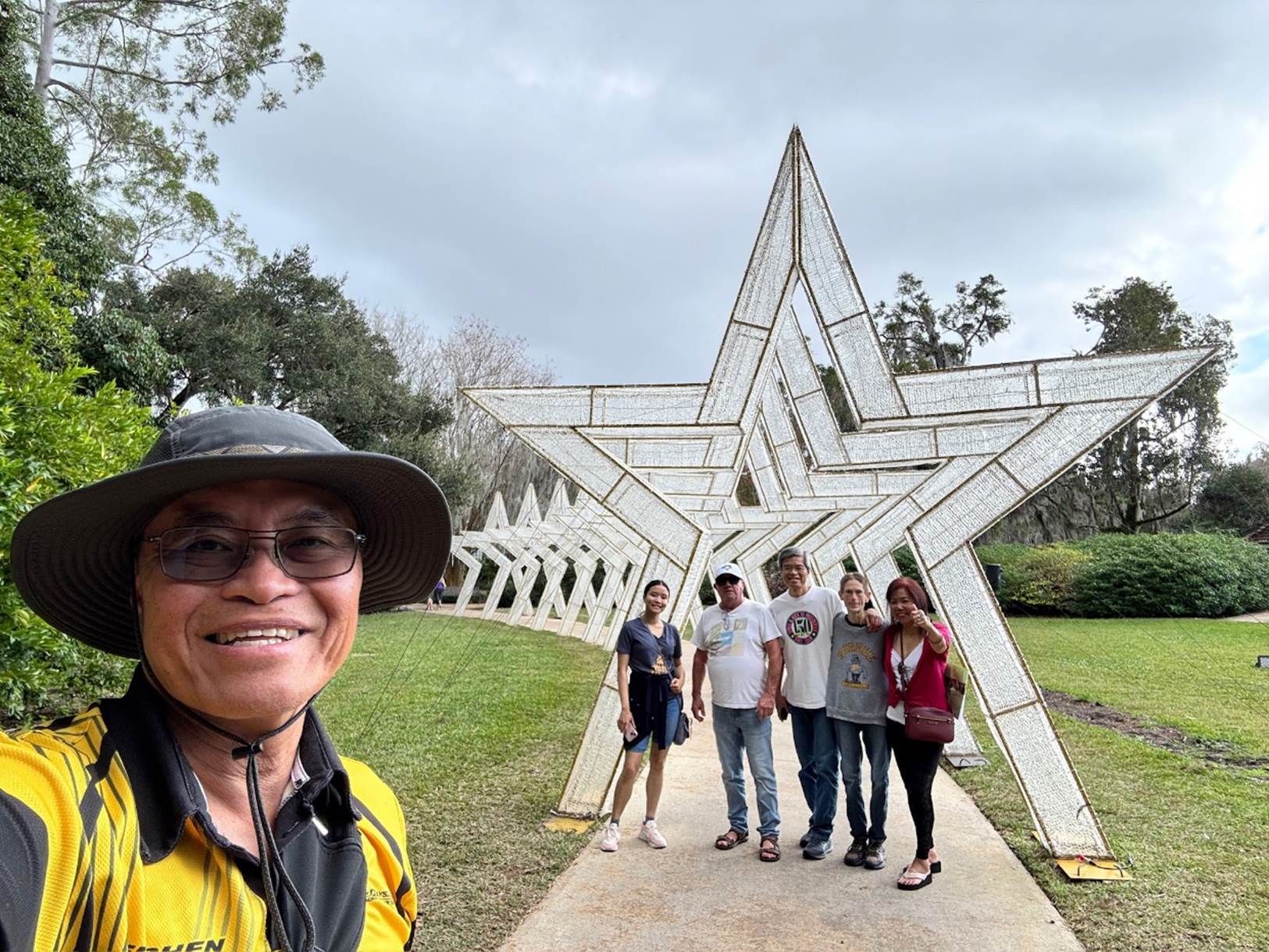 A group of people standing in front of a star shaped structure

Description automatically generated